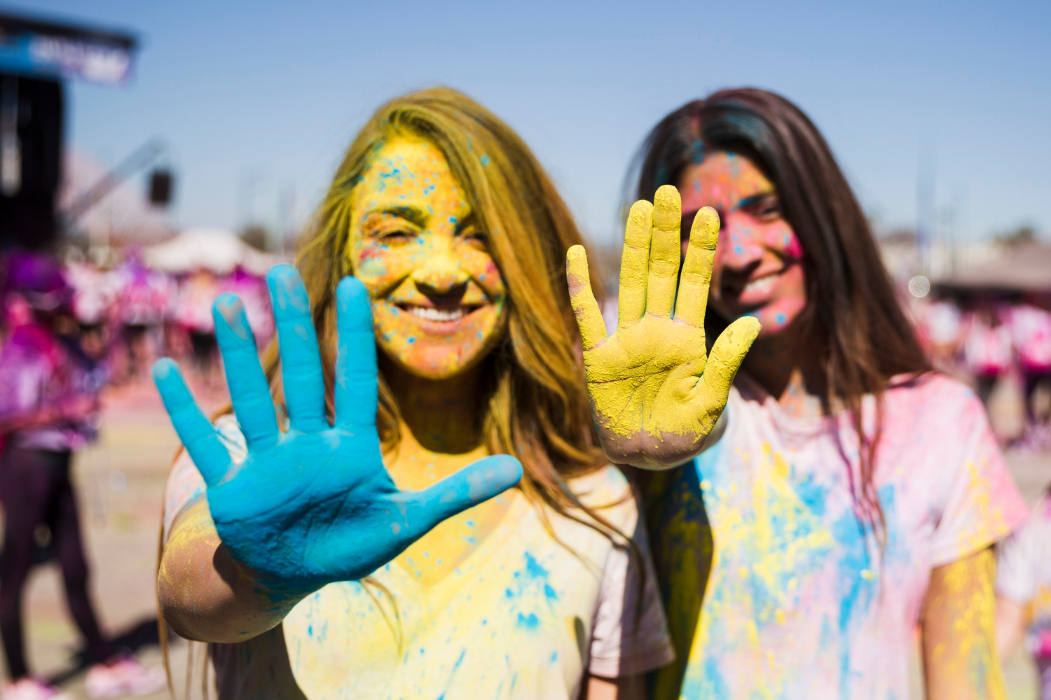 Image of young people with colored powder.
